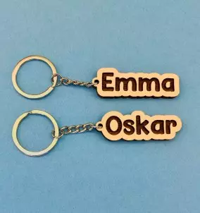 Personalized Keychain With Custom Name Engraving. Comic style name engraving on keyring.